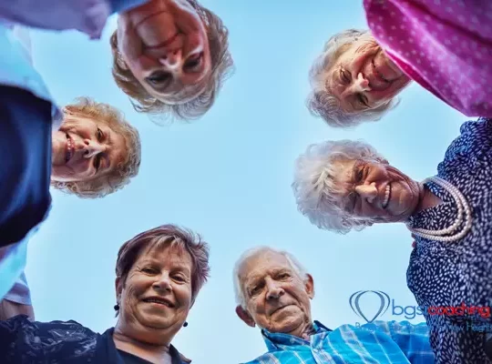 Living Life | BGSICoaching | 7 senior adults looking down at camera